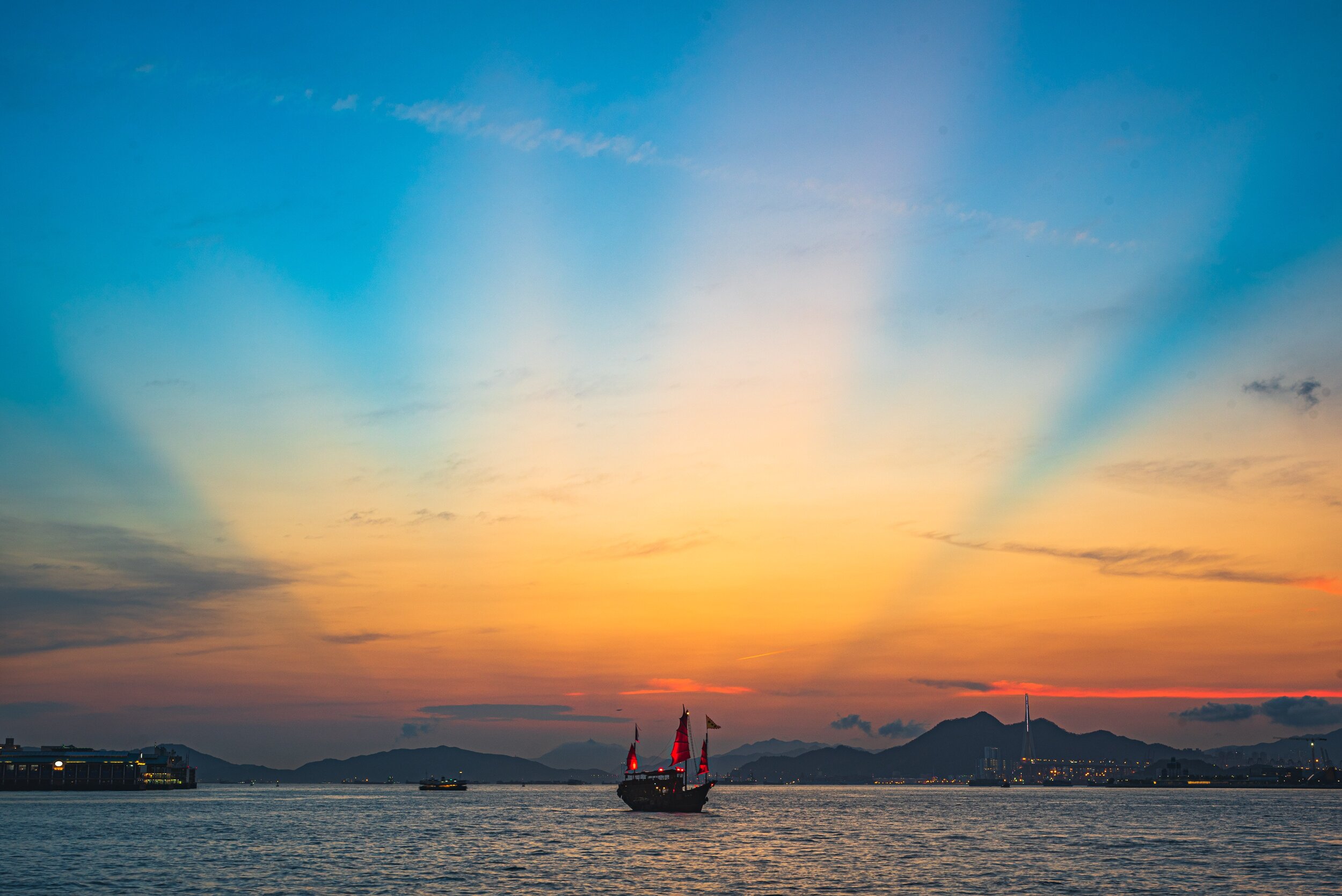 brown-and-red-junk-sailing-at-harbor-during-sunset-2693295.jpg